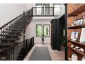 Bright open foyer featuring a staircase, wood floors, and large windows at 7070 Dean Rd, Indianapolis, IN 46220