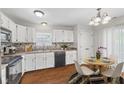 Eat-in kitchen with white cabinets, updated countertops, stainless steel appliances, and a cozy dining area at 7215 Wet Rock Ct, Indianapolis, IN 46236