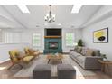 Bright living room featuring skylights, hardwood floors, fireplace, and contemporary furnishings at 7215 Wet Rock Ct, Indianapolis, IN 46236