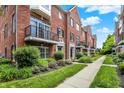 Charming brick townhouses line a sidewalk with lush green landscaping at 73 11Th Nw St, Carmel, IN 46032