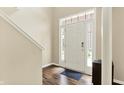 Bright entryway with hardwood floors and natural light from a large window at 73 11Th Nw St, Carmel, IN 46032