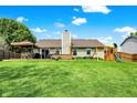 Spacious backyard featuring a large deck with pergola and a playset for children at 7437 Lorene Ct, Indianapolis, IN 46237