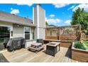 Deck area has outdoor furniture including a grill, picnic table, and outdoor fireplace at 7437 Lorene Ct, Indianapolis, IN 46237