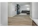 Open-concept living room with wood floors, a stylish accent wall and a comfortable sofa at 7724 Dunleer Dr, Brownsburg, IN 46112