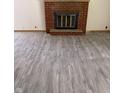 Bright living room featuring a brick fireplace and neutral flooring with a wooden trim at 8109 E Penway St, Indianapolis, IN 46226
