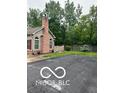 A well-maintained home featuring a brick chimney, manicured lawn, and tasteful landscaping at 811 Gazebo Way, Greenwood, IN 46142