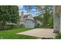 Backyard featuring a shed, concrete patio, partial fence, and green grass at 8121 Sand Ridge Cir, Indianapolis, IN 46237