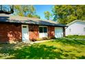 Charming single-story brick home with well-manicured lawn and attached garage at 8744 Montery Ct, Indianapolis, IN 46226