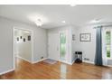Bright foyer with hardwood flooring, a glass-accented front door, and neutral paint at 8752 Washington Blvd E Dr, Indianapolis, IN 46240