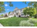 Two-story brick house featuring a three-car garage and beautiful lawn with professionally landscaped yard at 8973 Carnation Dr, Noblesville, IN 46060