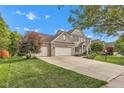 Beautiful two-story brick home with a large driveway, three-car garage, and well-maintained front yard at 8973 Carnation Dr, Noblesville, IN 46060