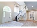 Elegant foyer boasts high ceilings, grand staircase, and stylish light fixture, creating a welcoming atmosphere at 9154 Sargent Manor Ct, Indianapolis, IN 46256