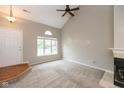 Bright living room with large windows, a fireplace, and high vaulted ceilings with ceiling fan at 11051 Oakridge Dr, Fishers, IN 46038