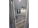 View into bedroom with new gray floors, black curtains and a modern ceiling fan at 1205 Meadow Ln, Lebanon, IN 46052