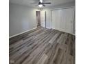 Spacious bedroom featuring sleek gray flooring, ceiling fan, and ample closet space at 1205 Meadow Ln, Lebanon, IN 46052