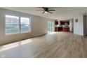 Open-concept living room with slider door, wood-look floors, and adjacent kitchen area at 1305 Gleneagle Dr, Indianapolis, IN 46239