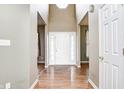 Bright foyer featuring a high ceiling, hardwood floors, and a white front door with sidelights at 1306 Flat Wood Ct, Brownsburg, IN 46112