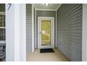 Exterior front door view showcasing a simple, gray-toned design and a clean, welcoming entrance at 13817 Black Canyon Ct, Fishers, IN 46038
