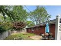 Spacious backyard featuring a patio with table and chairs, garden, and privacy fence at 1422 Dallas Dr, Plainfield, IN 46168