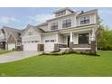 Inviting two-story home featuring a three-car garage, professional landscaping, and neutral-colored siding at 1510 Stonehaven Dr, Westfield, IN 46074