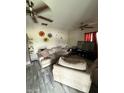 A spacious living room featuring tile floors, ceiling fans, and a cozy seating area at 1524 W 21St St, Indianapolis, IN 46202