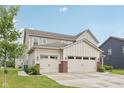 Charming two-story home featuring a three-car garage and well-manicured lawn at 15418 Tattersalls Ln, Fishers, IN 46040