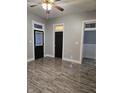 Neutral living area with modern wood floors, black doors, and easy access to other rooms at 179 E Pearl St, Greenwood, IN 46143