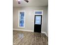 Bright living room with stylish wood flooring, neutral paint, and modern black doors at 179 E Pearl St, Greenwood, IN 46143