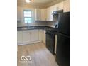 Bright kitchen features white cabinets, modern appliances, and sleek countertops at 1820 S M St, Elwood, IN 46036