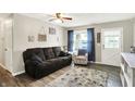 Inviting living room featuring a comfortable sofa, patterned armchair, and light-filled ambiance at 200 Forum Dr, Whiteland, IN 46184
