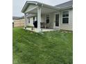 Relaxing covered patio featuring comfortable seating, a grill, and a well-maintained lawn at 200 Mission Terrace Dr, Whiteland, IN 46184