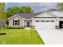 A well-kept home with stone details, dark shutters, a neat lawn and a two-car garage at 200 Mission Terrace Dr, Whiteland, IN 46184