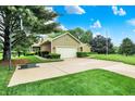 Spacious driveway leading to a home with mature trees and landscaping, and a basketball hoop at 201 Angela Ct, Noblesville, IN 46062