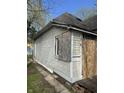 Side view of an older, distressed home with boarded windows and exposed siding at 330 N Lasalle St, Indianapolis, IN 46201