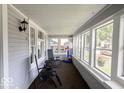 Relaxing enclosed porch with many windows, comfortable seating, and natural light at 3934 N Kenwood Ave, Indianapolis, IN 46208