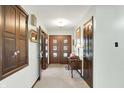 Bright and airy foyer featuring hardwood floors and elegant wood accents at 415 Woodhill Dr, Indianapolis, IN 46227