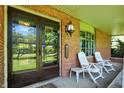 Inviting covered front porch with classic brick accents and comfortable seating at 415 Woodhill Dr, Indianapolis, IN 46227