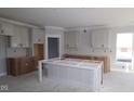 Bright kitchen featuring modern white cabinets and a large island at 4290 Ironclad Dr, Bargersville, IN 46106