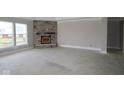 Bright, spacious living room with stone fireplace and large windows at 4290 Ironclad Dr, Bargersville, IN 46106