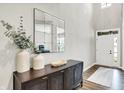 Bright foyer with high ceilings, decorative mirror and table, and a white front door at 4602 Hayward Way, Westfield, IN 46062