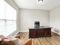 Inviting office featuring a large desk, leather chair, and a cozy armchair by the window at 4602 Hayward Way, Westfield, IN 46062
