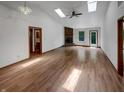 Spacious living room featuring vaulted ceilings, skylights, and hardwood floors at 4825 May Ridge Ln, Indianapolis, IN 46254