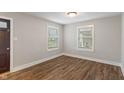 Bright bedroom with hardwood floors and natural light from two windows at 5473 E 18Th St, Indianapolis, IN 46218