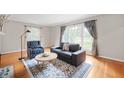 Bright living room filled with natural light, hardwood floors, stylish furniture, and elegant window coverings at 6020 Gladden Dr, Indianapolis, IN 46220