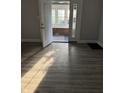 Sunlit entryway showing vinyl floors, neutral paint, and entrance to a porch at 701 N Gladstone Ave, Indianapolis, IN 46201