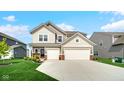 Charming two-story home featuring a three-car garage and well-manicured lawn at 7226 Sayers Rd, Indianapolis, IN 46259