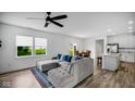 Bright living room featuring a comfortable gray sectional and modern ceiling fan at 7226 Sayers Rd, Indianapolis, IN 46259