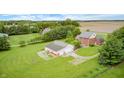 Wide aerial view of the beautiful home, detached garage, and surrounding mature trees at 7333 State Road 42, Martinsville, IN 46151