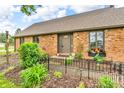 Up-close exterior of brick house with flower boxes, manicured landscaping, and a welcoming walkway at 7633 Janean Dr, Brownsburg, IN 46112