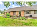 Inviting exterior showcasing the brick facade, manicured landscaping, and quaint flower boxes at 7633 Janean Dr, Brownsburg, IN 46112